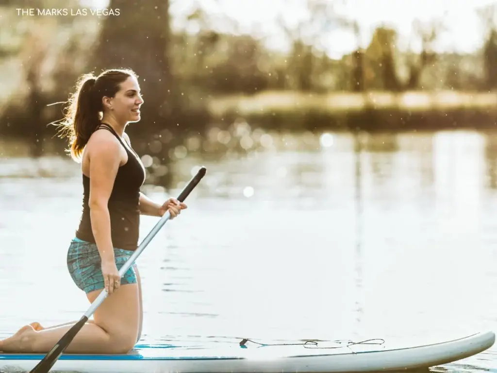 Residents paddle boarding on Lake Las Vegas near luxury homes and desert peaks